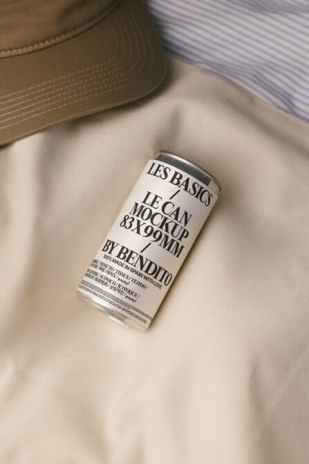 White can mockup with black label on beige fabric with striped shirt