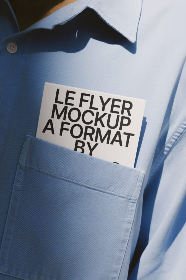 White leaflet with black text in light blue shirt breast pocket