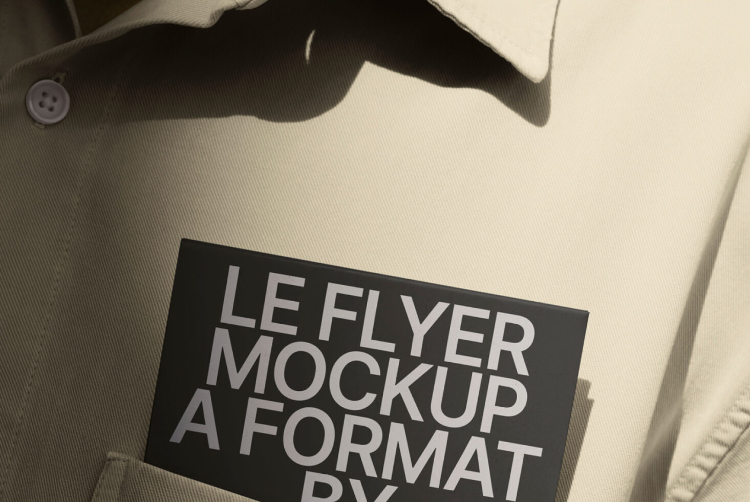 Black leaflet mockup displayed on cream linen blazer with natural shadow