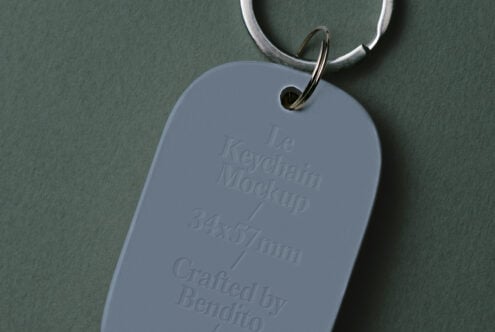 Periwinkle keychain tag showing embossed details on sage background