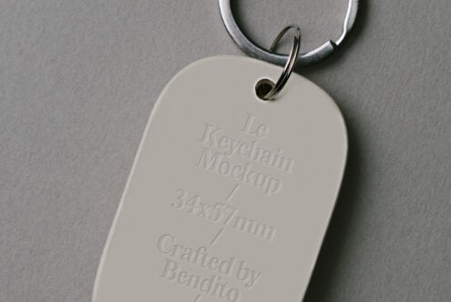 Cream keychain tag showing embossed details on gray background