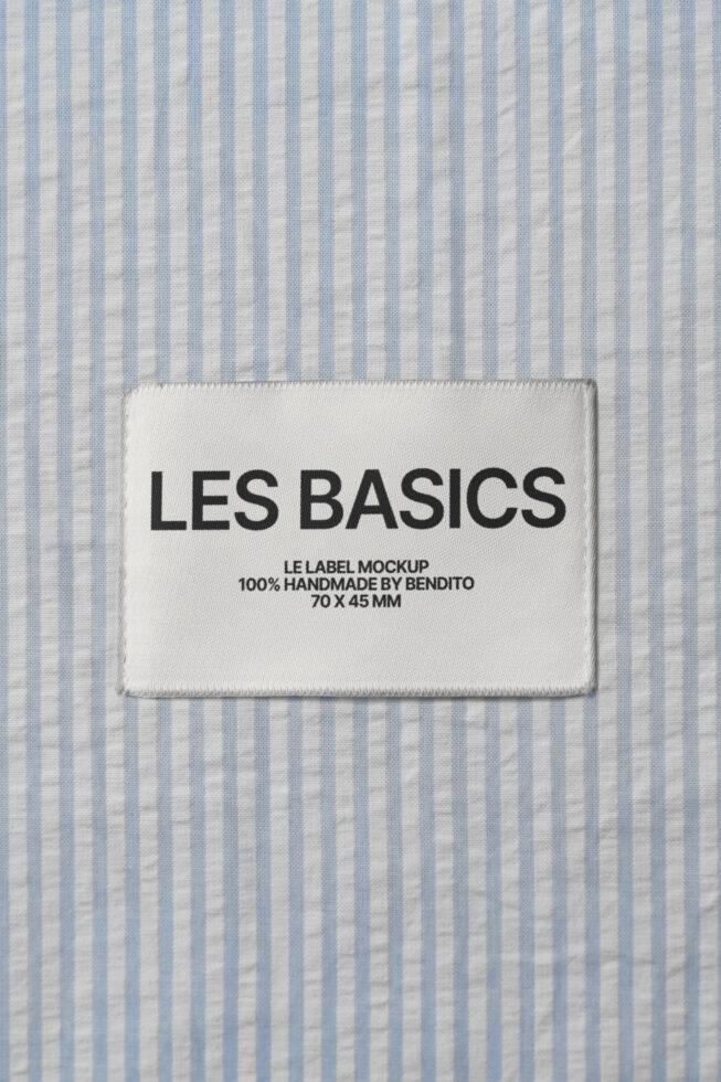 White woven label on blue striped fabric with Les Basics branding