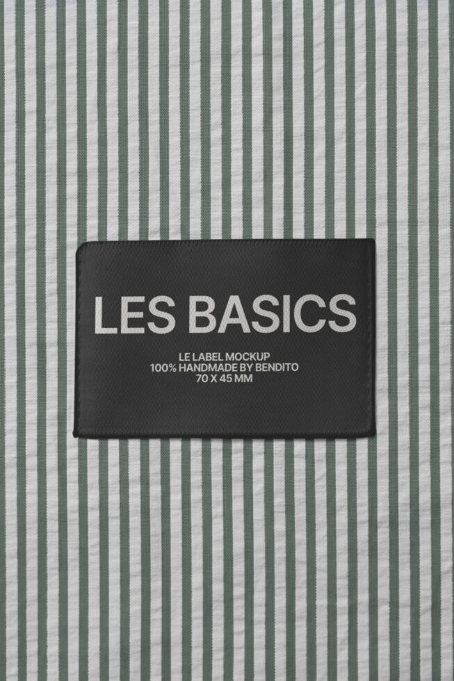Black woven label on sage striped fabric with Les Basics branding