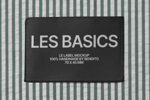 Black woven label on green striped fabric with Les Basics branding