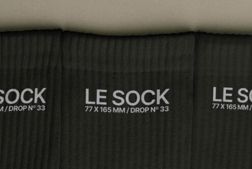 Overhead shot of black ribbed socks with white Le Sock label, drop number 33 visible