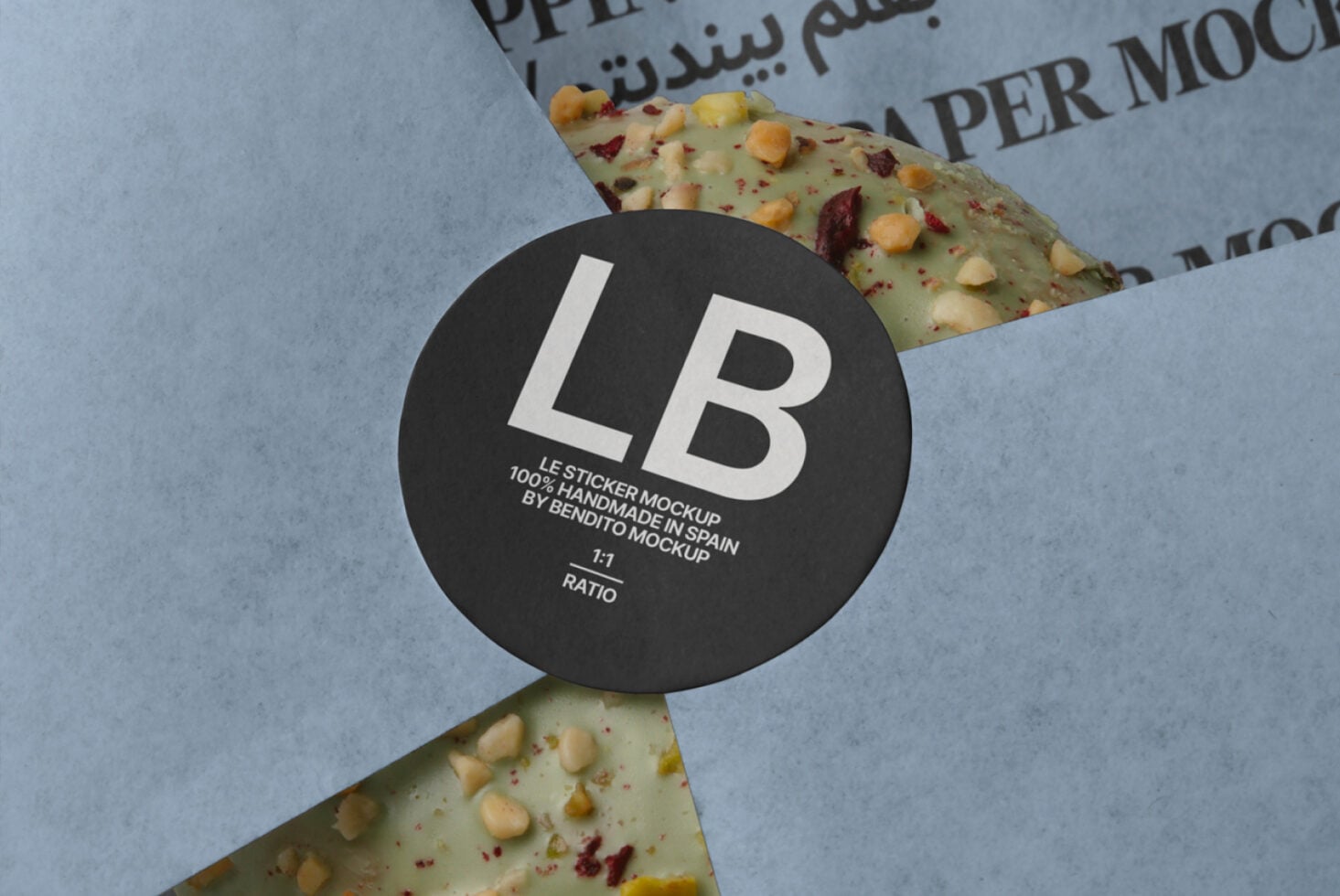 Black circular sticker mockup positioned on textured cracker surface with blue paper backdrop