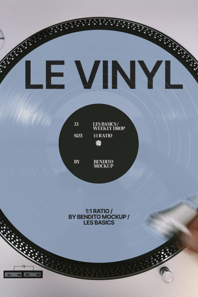Light blue vinyl record with black dotted rim displaying Les Basics Weekly Drop details on label