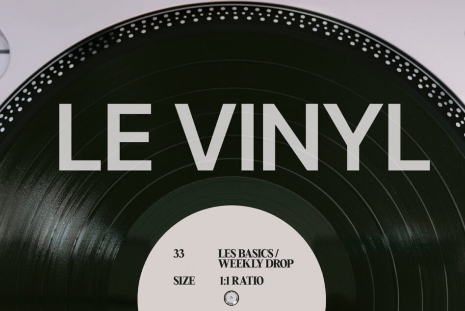 Black vinyl record with white center label featuring Les Basics Weekly Drop details