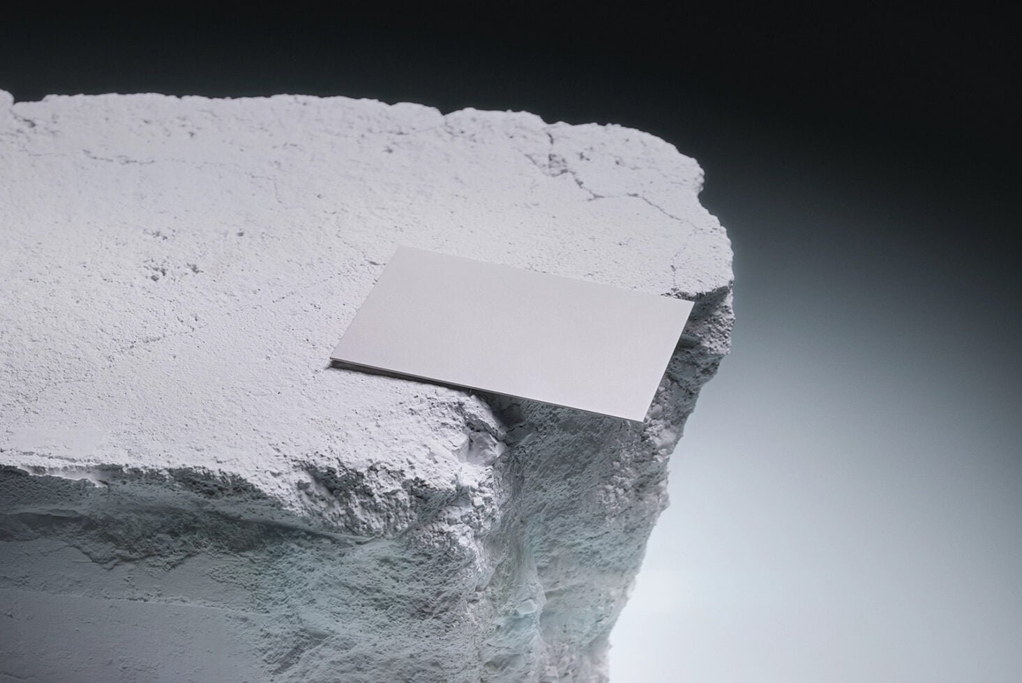 Blank business card mockup on white cliff edge against dark sky