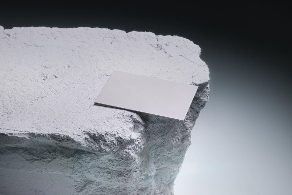 Blank business card mockup on white cliff edge against dark sky