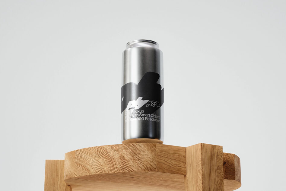 Metallic can with black label mockup positioned on sculptural wood base