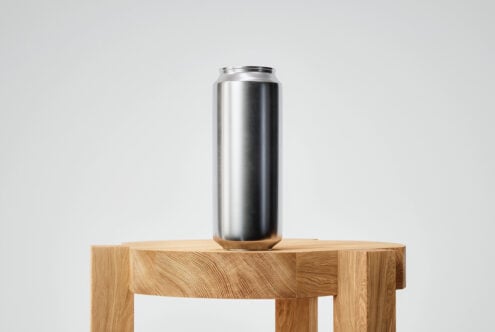 Blank metallic aluminum can on wooden block with clean minimal setup