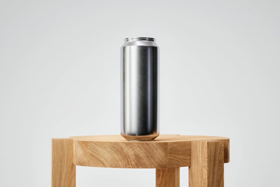 Blank metallic aluminum can on wooden block with clean minimal setup