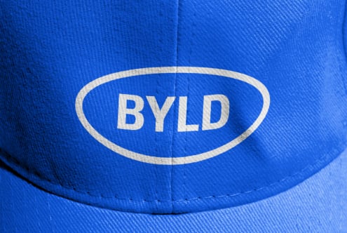 Close up of blue cap front with BYLD oval logo patch