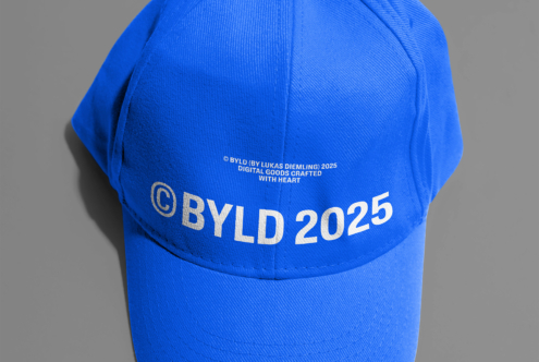 Bright blue cap with gold BYLD 2025 text, grey background