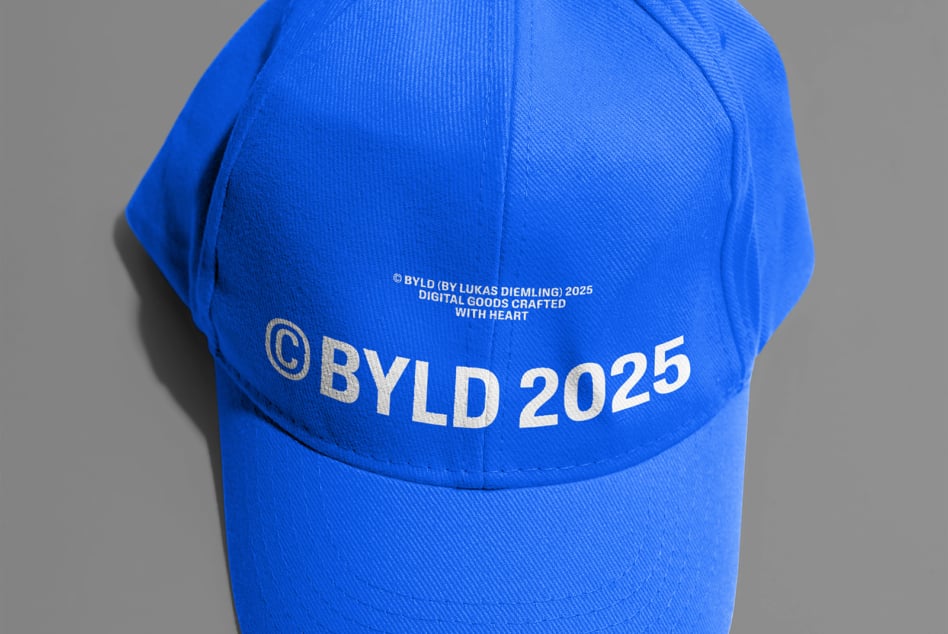 Bright blue cap with gold BYLD 2025 text, grey background