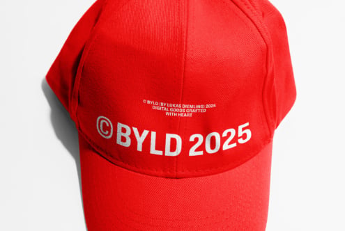 Red cap overhead view showing silver BYLD 2025 branding