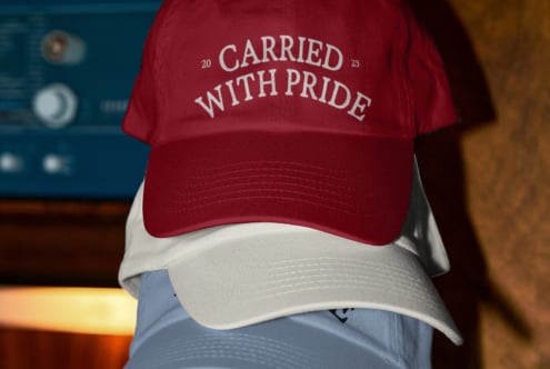 Burgundy, white, blue stacked caps showing Carried With Pride design