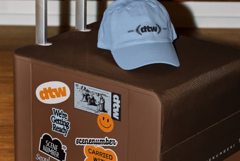 Light blue cap mockup with stickers on brown hand cart display