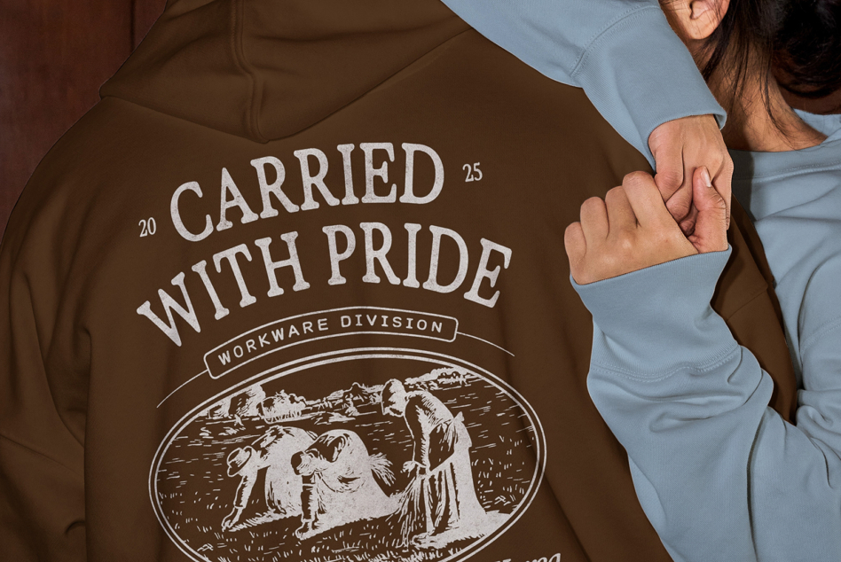 Brown hoodie featuring Carried with Pride workwear division print with engraved figures