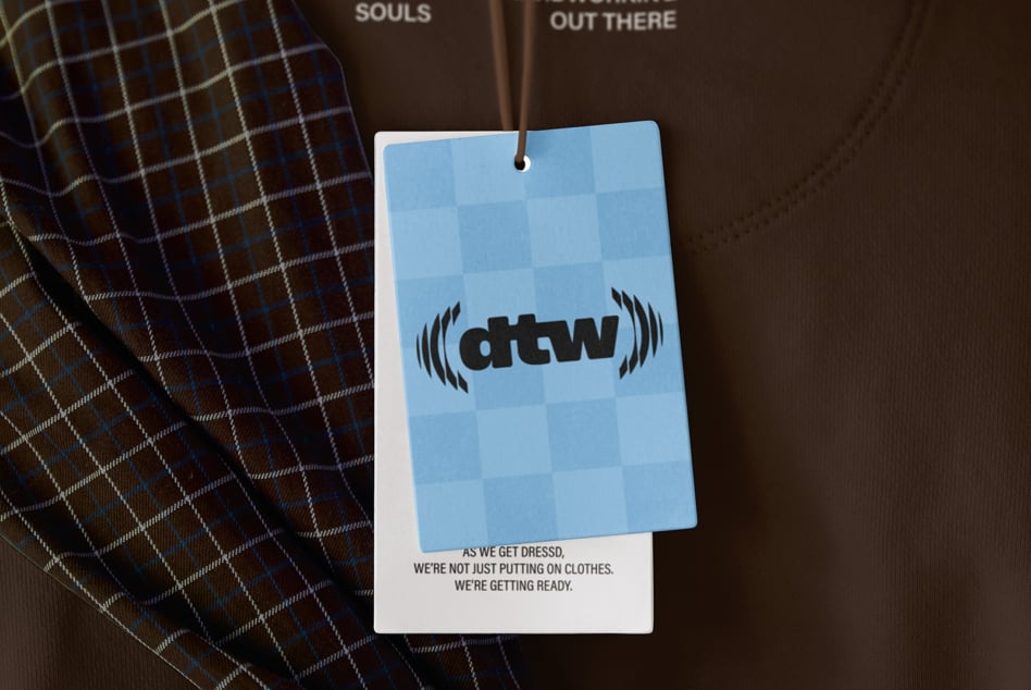 Blue hang tag mockup with checkered pattern on brown sweatshirt