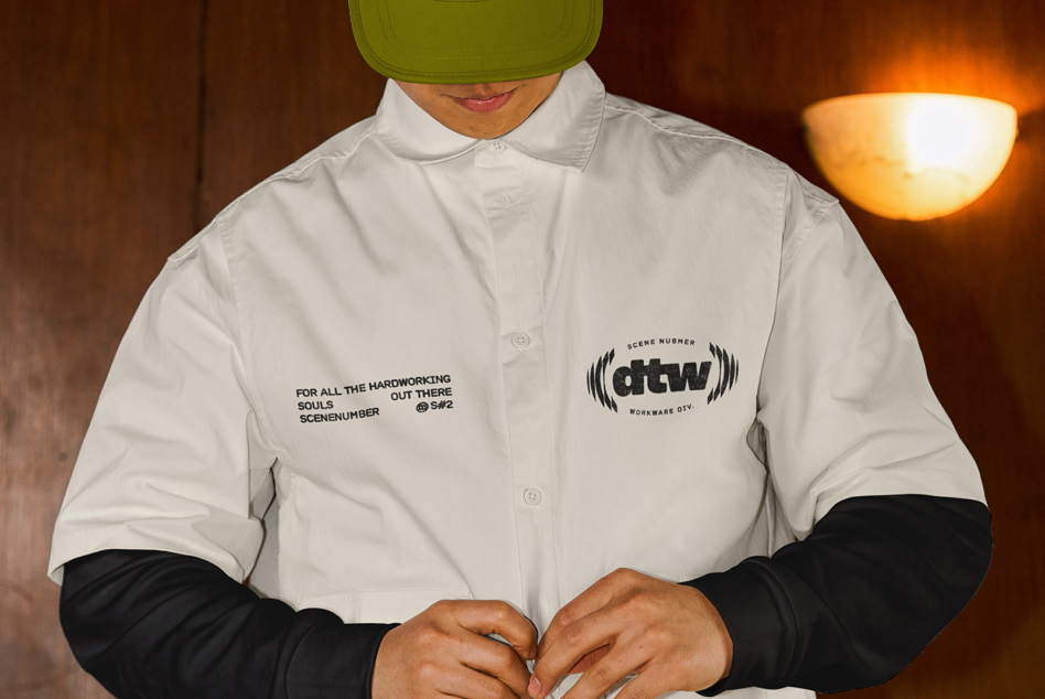 White button-up shirt with printed text reading 'For all the hardworking souls out there' worn with lime green cap