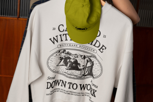 Lime camp cap mockup hanging from light blue sweatshirt with back print
