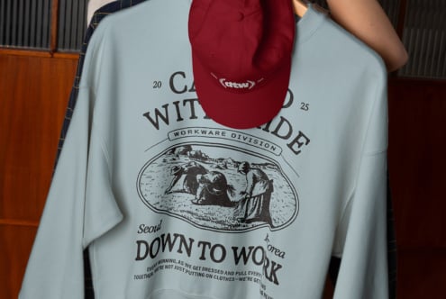 Burgundy camp cap mockup displayed above light blue crewneck sweatshirt