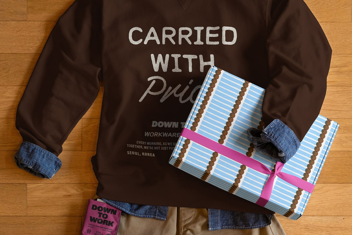 Dark sweatshirt front showing blue striped box mockup with pink ribbon customizable wrapping design