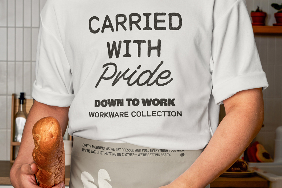 Person holding fresh croissant wearing white tee with Carried with Pride text mockup