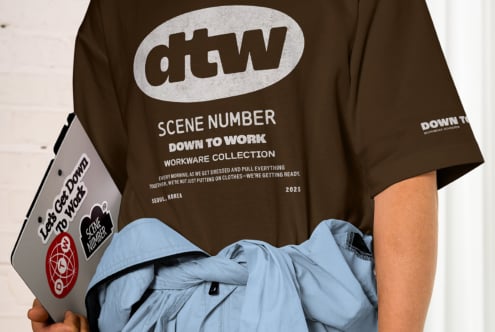 Brown tee front showing dtw oval logo, scene number, down to work workware collection