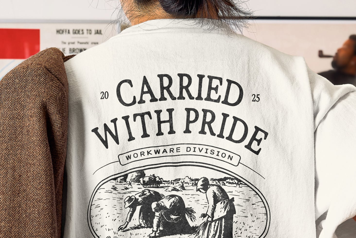 Cream tee featuring Carried With Pride large text over landscape engraving illustration