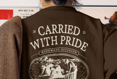 Dark brown tee with large Carried With Pride text over engraved pastoral scene art