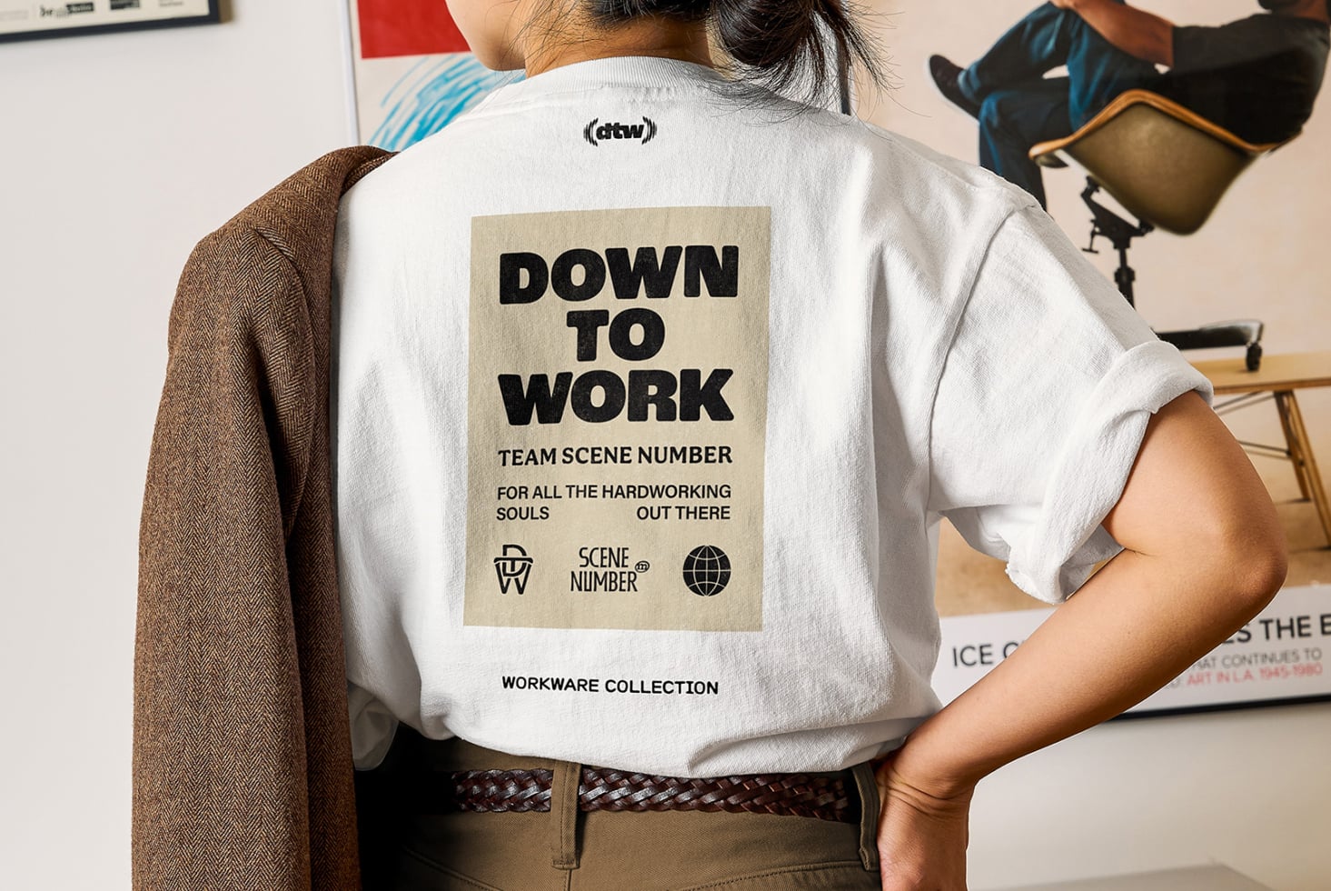 White shirt back showing Down To Work patch with scene number logo icons below