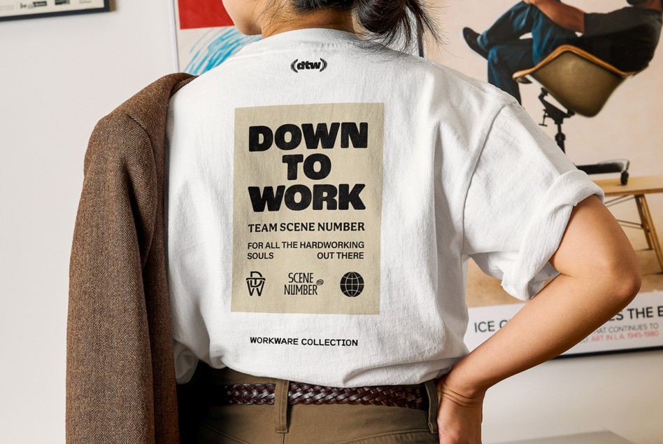 White shirt back showing Down To Work patch with scene number logo icons below