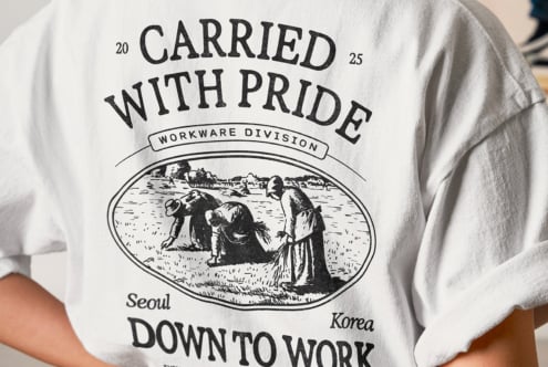 Person wearing white crewneck tee with retro workwear design from Seoul Korea