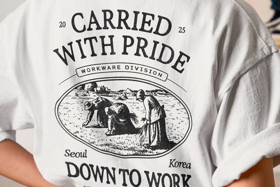 Person wearing white crewneck tee with retro workwear design from Seoul Korea