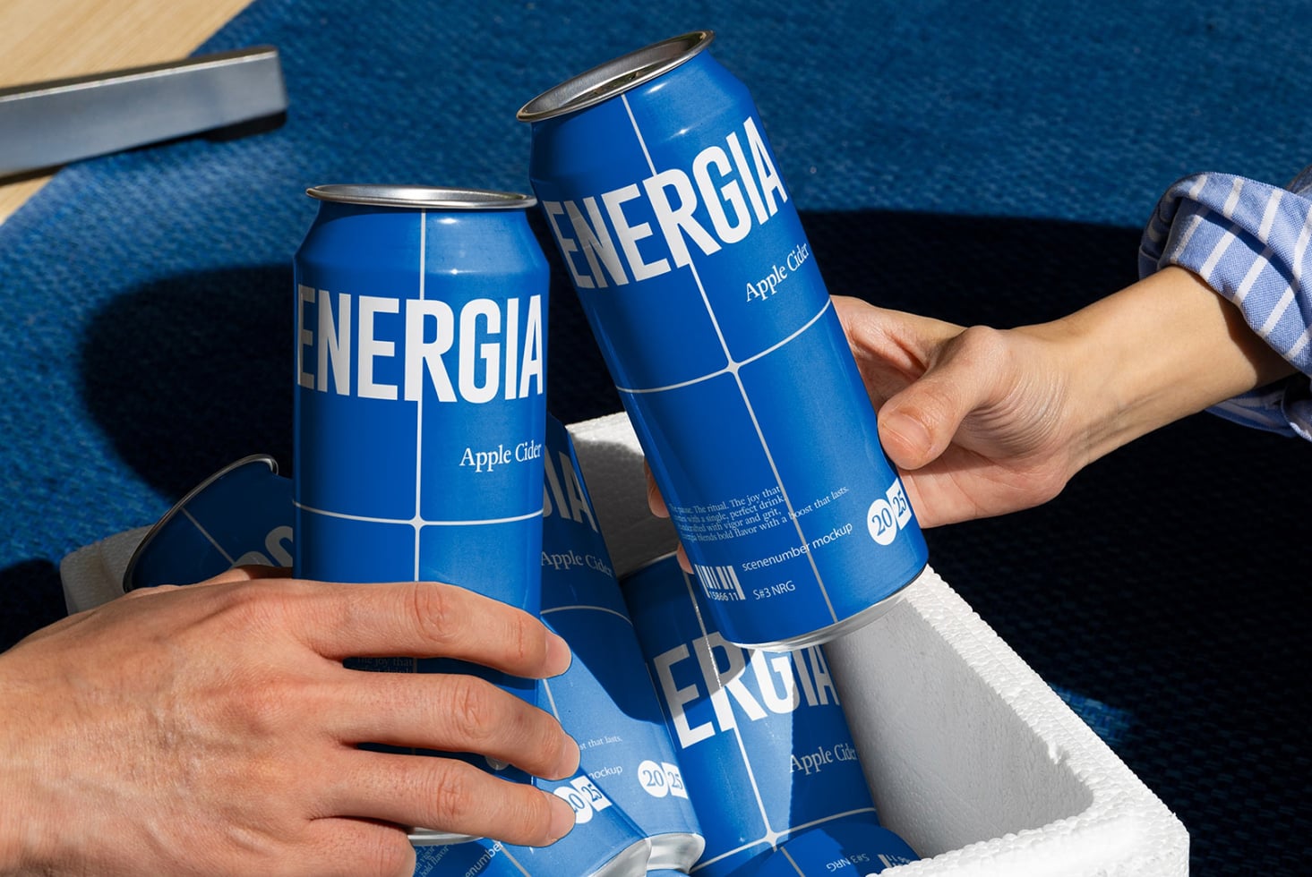 Two people cheers with white ENERGIA cans on blue textured background