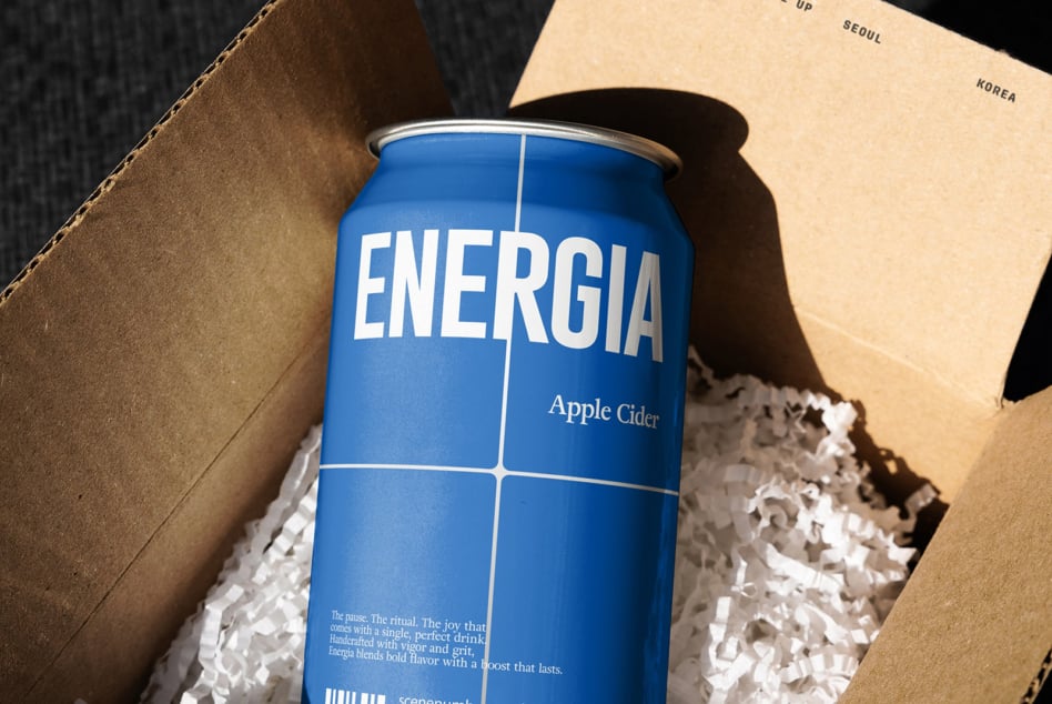 ENERGIA apple cider can nestled in cardboard box with kraft paper