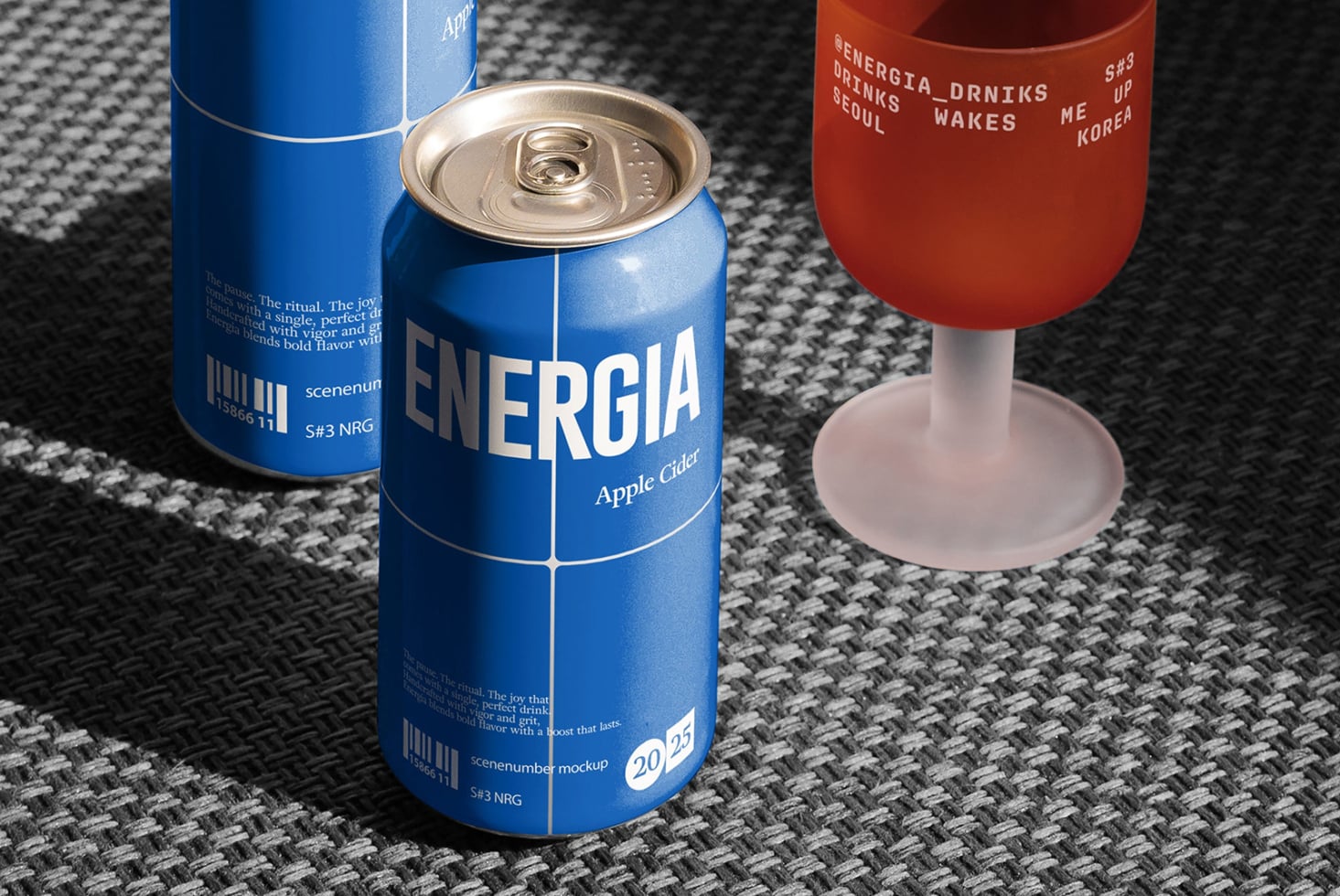 Blue cans with red wine glass on textured gray fabric backdrop