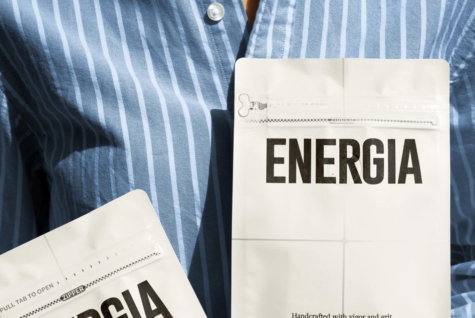 Striped shirt with white packet showing ENERGIA, open zipper detail, grid pattern visible