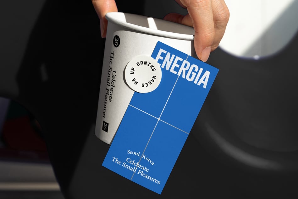 White can with blue card overlay showing Energia drink label, circular sticker detail