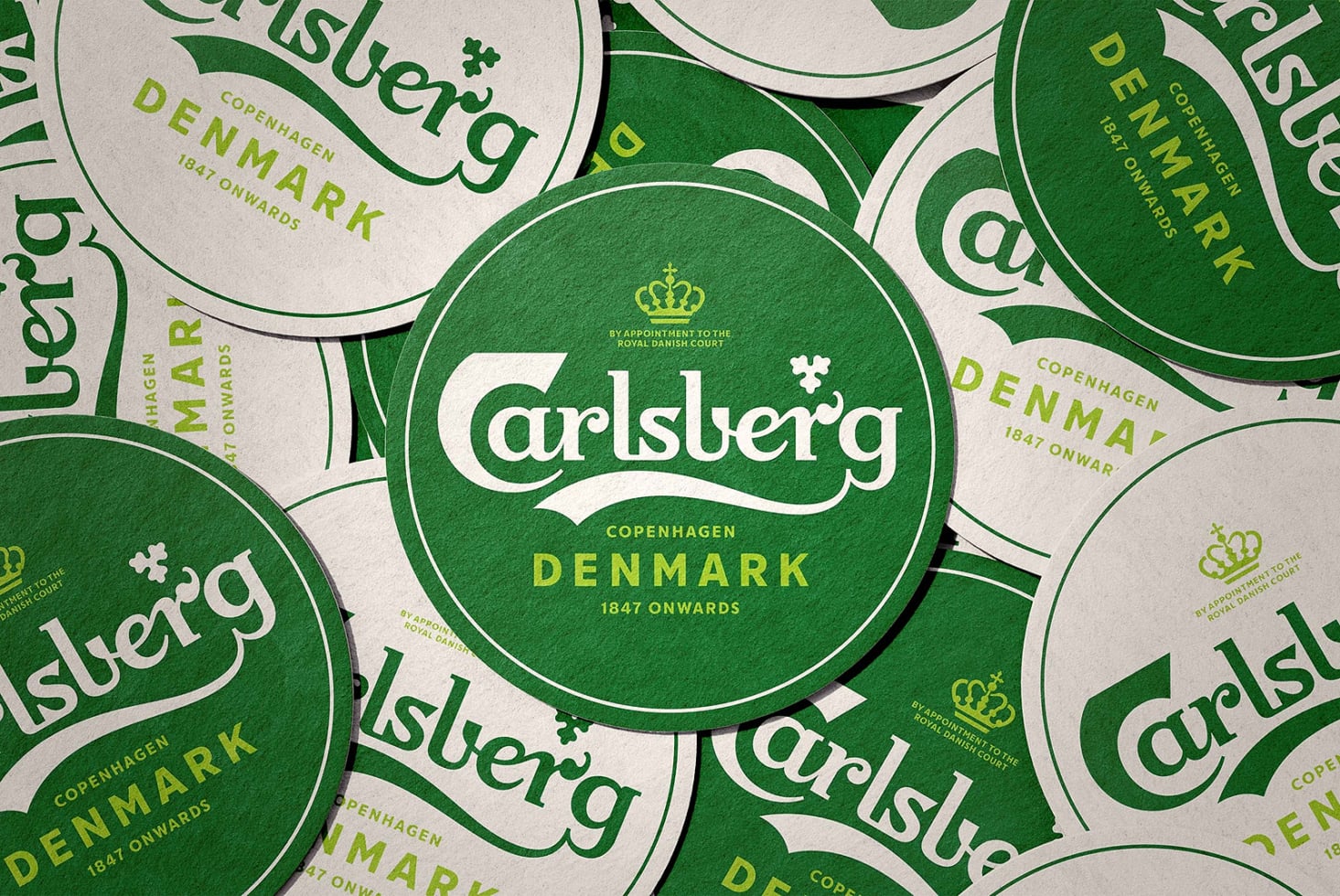 Overhead shot of stacked Carlsberg coasters, Copenhagen Denmark branding layout