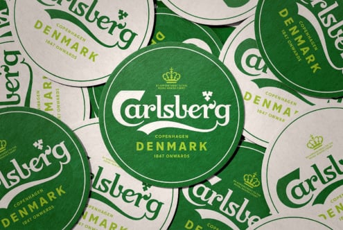 Overhead shot of stacked Carlsberg coasters, Copenhagen Denmark branding layout