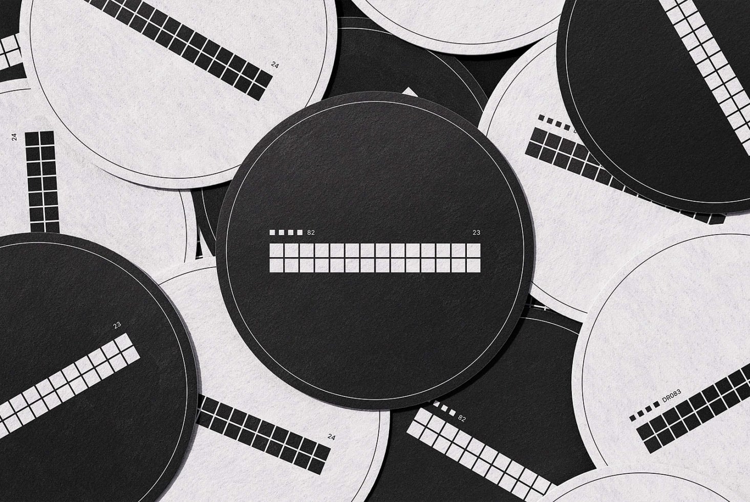 Black white circular color checker swatches arranged on textured paper background