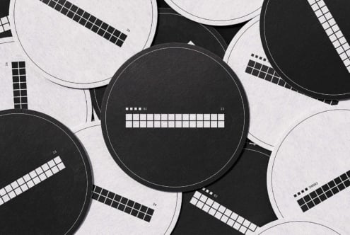 Black white circular color checker swatches arranged on textured paper background