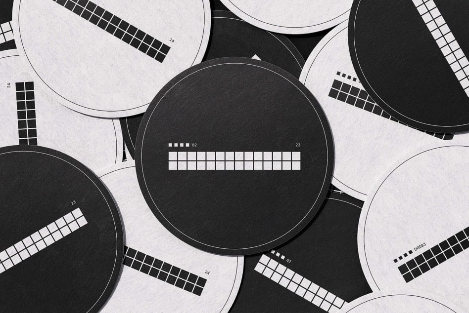 Black white circular color checker swatches arranged on textured paper background