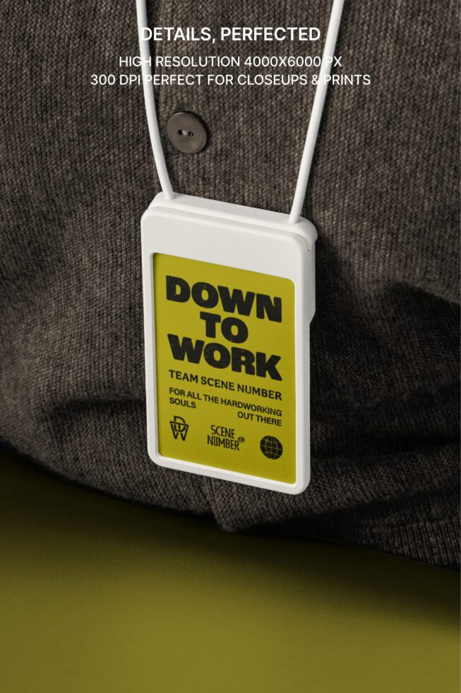 White lanyard badge on gray knit cardigan, Down to Work text with yellow background