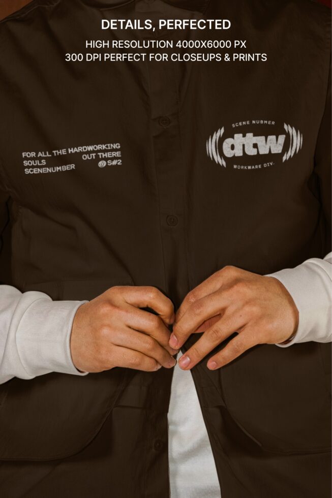 Close up of brown button up shirt with dtw logo detailing between hands