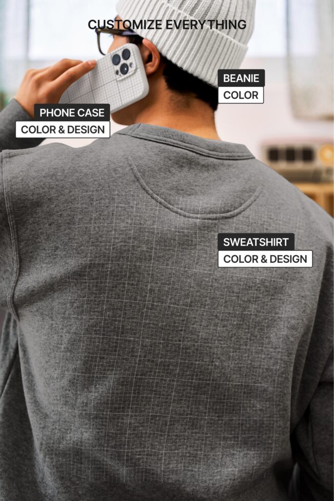 Back view of gray sweatshirt with phone case visible, beanie, casual pose